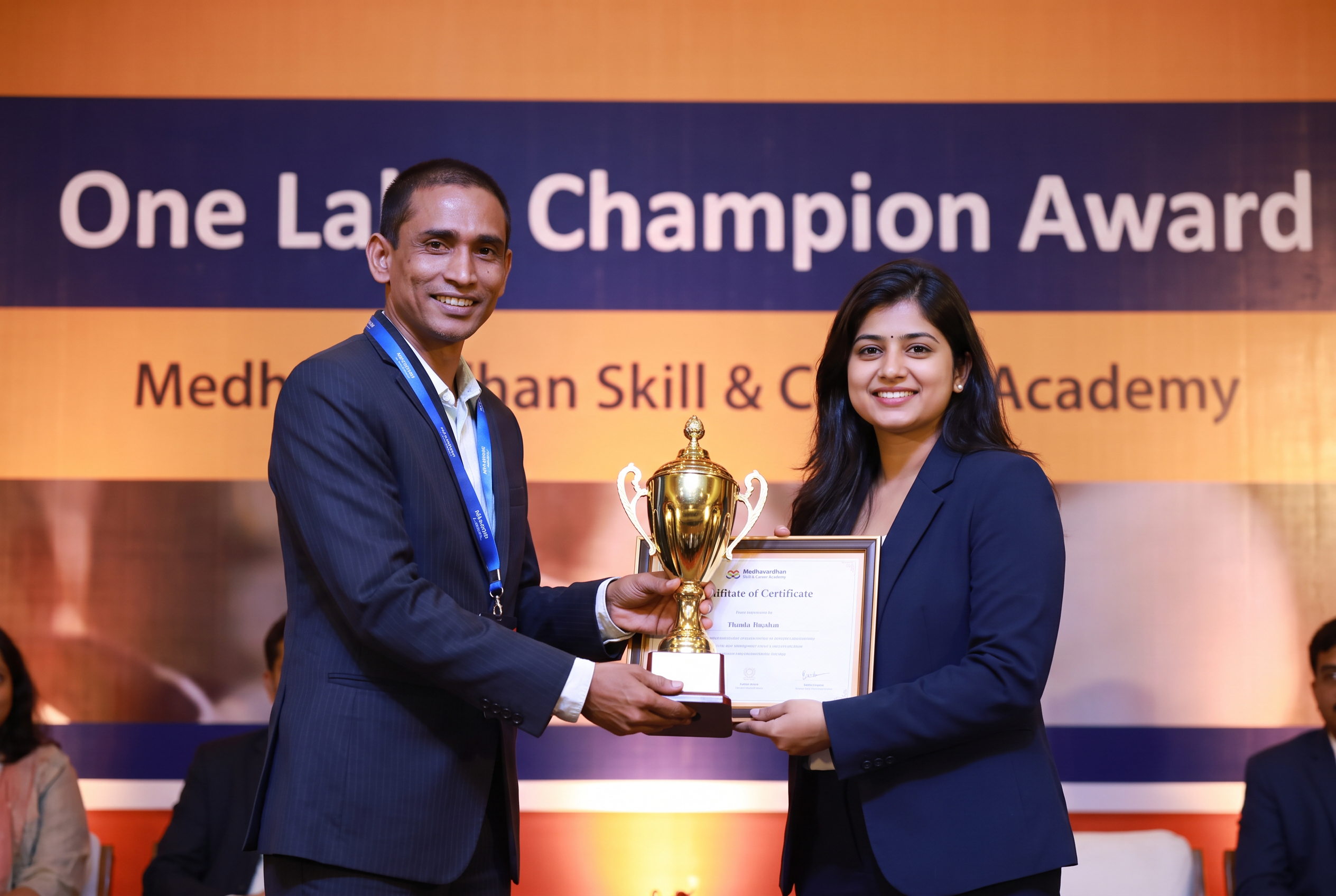 Ananya Chatterjee receiving the One Lakh Champion Award from the founder of Medhavardhan Skill & Career Academy
