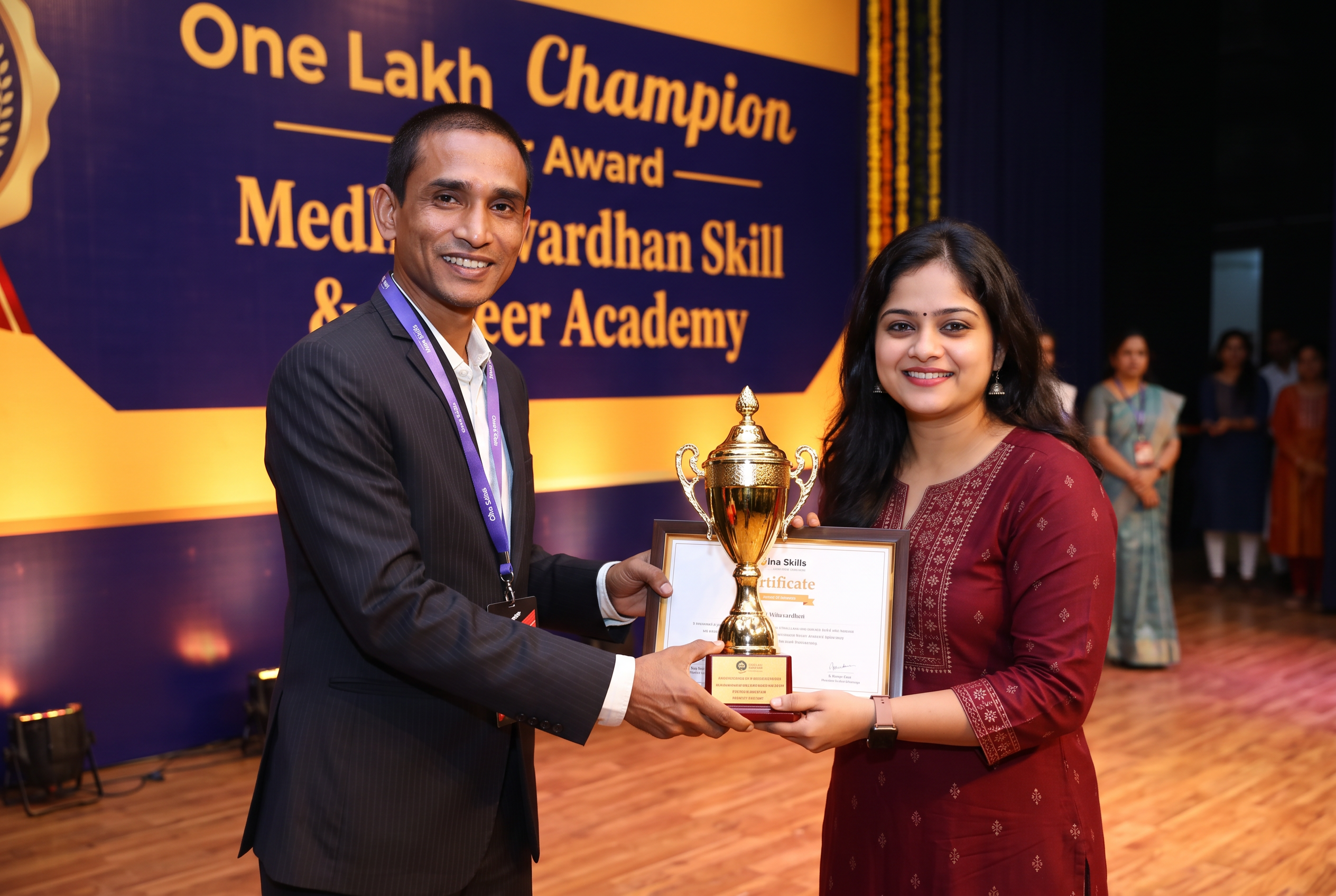 Priyanka Mondal receiving the One Lakh Champion Award from the founder of Medhavardhan Skill & Career Academy