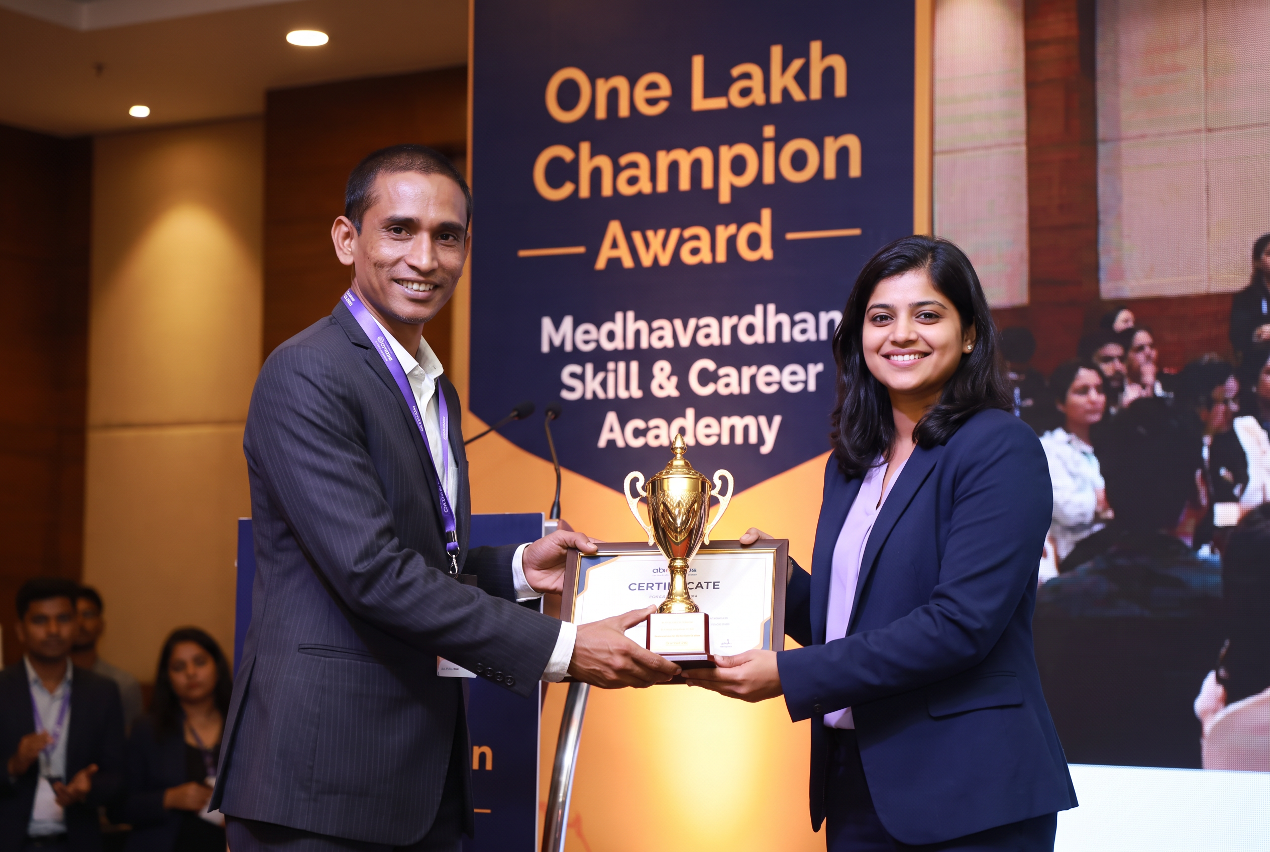 Moushumi Nandi receiving the One Lakh Champion Award from the founder of Medhavardhan Skill & Career Academy
